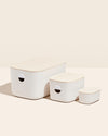The Open Spaces Trio Bin Set with wooden lids on a cream background. 