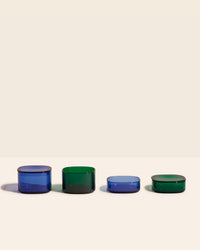 The Blue & Dark Green  4 piece Storage gems on a cream background. 