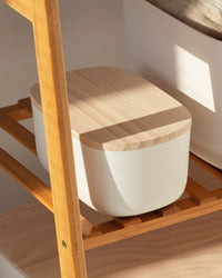 Close up view for the Open Spaces Small Cream Storage Bin with a wooden lid on a wooden rack.