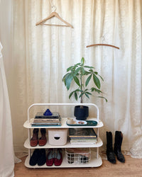 The Open Spaces Entryway Rack on a white background with items displayed on it. 