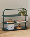 The Open Spaces Dark Green Entryway Rack on a gray background with items displayed on it.