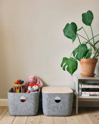 Open Spaces Large Felt Storage bins, one with toys stored in it on a cream background.