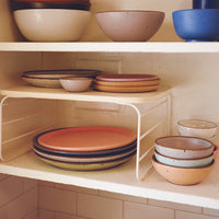 The Open Spaces Shelf Risers on a kitchen countertop. 