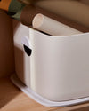 Close up front view for the Open Spaces Large Cream Storage Bin with rolls of paper stored in it.