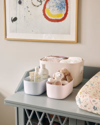 2 Small Storage Bins and 1 large Storage Bin with contents on a grey shelf. 