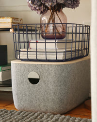 The Opens Spaces Large Navy Wire Baskets placed on top of a Large Felt Bin.
