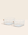 Two Open Spaces Light Blue Wire Baskets on a cream background. 
