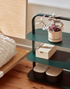 OS Dark Green Entryway Rack used at a bed side. 